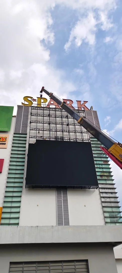 Large outdoor LED billboard being installed on a commercial building